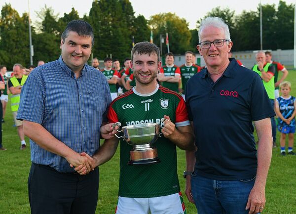 Winning St. Brigid's captain Paul McGrath is presented with the O’Rourke Cup by Roscommon GAA Chairperson, Brian Carroll, and Philip Martin, Cora Systems, Division One Football League sponsor. Picture: Gerard O’Loughlin Winning St. Brigid's captain Paul McGrath is presented with the O’Rourke Cup by Roscommon GAA Chairperson, Brian Carroll, and Philip Martin, Cora Systems, Division One Football League sponsor. Picture: Gerard O’Loughlin